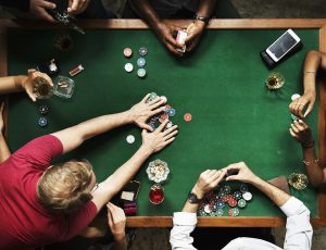 Diverse group playing poker and socialising